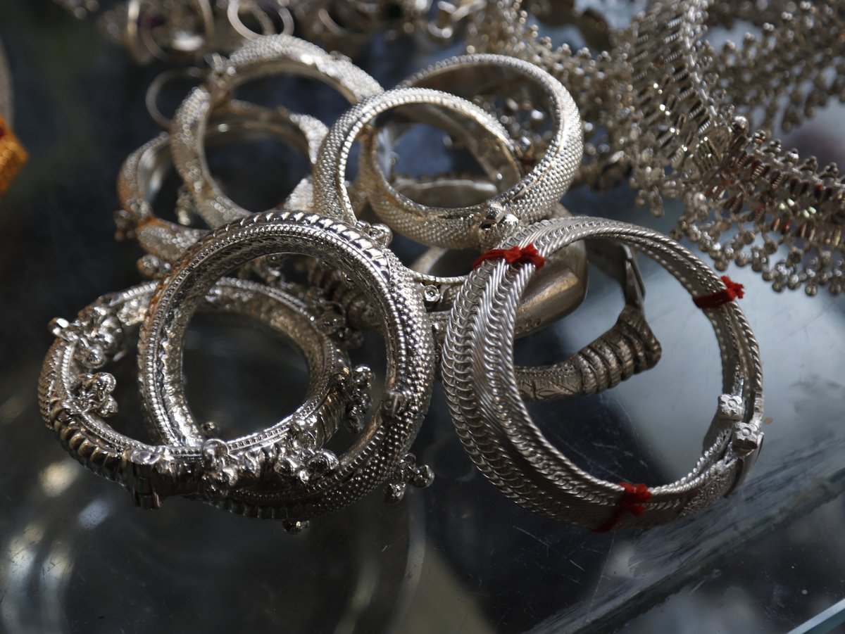 Close-up of handcrafted silver bangles and traditional South Asian metalwork